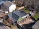 Aerial view displays the property with fenced backyard, landscaping, and detached storage shed at 506 Campus St, Charlotte, NC 28216