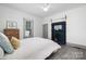 Bright bedroom featuring a decorative fireplace, ceiling fan, and window at 506 Campus St, Charlotte, NC 28216