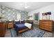 Cozy bedroom featuring blue accents, patterned wallpaper, and warm, natural light at 506 Campus St, Charlotte, NC 28216