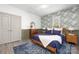 Stylish bedroom featuring blue accents, patterned wallpaper, and warm, natural light at 506 Campus St, Charlotte, NC 28216