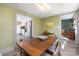 Olive dining room with rustic wooden table and views into the kitchen and office at 506 Campus St, Charlotte, NC 28216