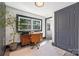 Bright office with a hardwood desk, large potted plant, and natural light from a large window at 506 Campus St, Charlotte, NC 28216