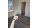 A sunlit empty bedroom with luxury vinyl floors and a modern bathroom at 523 W Front St, Statesville, NC 28677