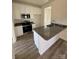 A bright kitchen featuring stainless steel appliances, granite countertops, and white cabinetry at 523 W Front St, Statesville, NC 28677