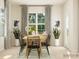 Dining area with wooden table, black chairs, and access to exterior at 5901 Oak Branch Cir, Maiden, NC 28650