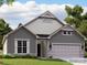 Two-story home with gray and beige siding, two-car garage, and landscaping at 5901 Oak Branch Cir, Maiden, NC 28650