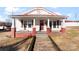 Charming home featuring a welcoming front porch with brick accents and benches at 601 N 12Th St, Bessemer City, NC 28016