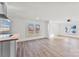 Sun-filled living room showcasing new flooring, light walls and eat-in kitchen island at 601 N 12Th St, Bessemer City, NC 28016