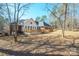 Brick house with a large deck and surrounding trees at 6238 Mountain Vine Ave, Kannapolis, NC 28081