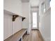 Bright entryway with long wooden bench, shelves, light wood floors and white walls at 718 Barrel Aly, Fort Mill, SC 29715