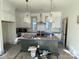 Modern kitchen with white cabinets, a large island, and stylish pendant lights at 718 Barrel Aly, Fort Mill, SC 29715