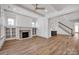 Bright living room with fireplace, built-in shelving, hardwood floors, and elegant beamed ceilings at 718 Barrel Aly, Fort Mill, SC 29715