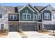 Attractive townhomes feature varied siding, stone accents, and attached garages at 8125 Houser St, Cornelius, NC 28031