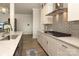 A modern kitchen features stainless appliances, a gray backsplash, and plenty of cabinet space at 8125 Houser St, Cornelius, NC 28031