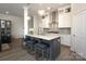 A large island features stainless steel appliances, pendant lighting, and seating in this open kitchen at 8125 Houser St, Cornelius, NC 28031