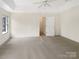 Large bedroom with carpet and access to hallway at 8200 Suttonview Dr, Charlotte, NC 28269