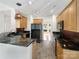 Kitchen with granite countertops, dark cabinetry, and black appliances at 8200 Suttonview Dr, Charlotte, NC 28269