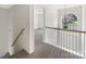 Upstairs hallway with arched window and chandelier at 8200 Suttonview Dr, Charlotte, NC 28269