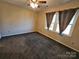 Bedroom with ceiling fan and neutral carpeting at 8225 Pineville Matthews Rd # H, Charlotte, NC 28226