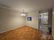 Dining area with hardwood floors and view of kitchen at 8225 Pineville Matthews Rd # H, Charlotte, NC 28226