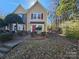 Two-story townhome with red door and landscaping at 8225 Pineville Matthews Rd # H, Charlotte, NC 28226