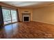 Bright living room featuring a fireplace and sliding glass doors to a patio at 8225 Pineville Matthews Rd # H, Charlotte, NC 28226