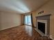 Living room with fireplace, sliding glass doors, and hardwood-style floors at 8225 Pineville Matthews Rd # H, Charlotte, NC 28226