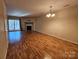 Spacious living room with hardwood floors and fireplace at 8225 Pineville Matthews Rd # H, Charlotte, NC 28226