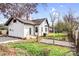 Backyard featuring green grass, trees, a small deck and a white house with black trim at 8228 Moores Chapel Rd, Charlotte, NC 28214