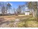 Spacious backyard featuring grass, dirt, trees and an outbuilding at 8228 Moores Chapel Rd, Charlotte, NC 28214