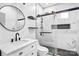 Modern bathroom features a marble countertop vanity, a round mirror, and a glass shower with black hardware at 8228 Moores Chapel Rd, Charlotte, NC 28214