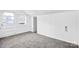 Attic bedroom with neutral carpet, white walls, a door to a porch, and a window at 8228 Moores Chapel Rd, Charlotte, NC 28214