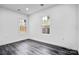 Bright bedroom with two windows allowing natural light and dark hardwood floors at 8228 Moores Chapel Rd, Charlotte, NC 28214