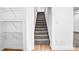 Hallway shows carpeted stairs with white walls and a storage area on the side at 8228 Moores Chapel Rd, Charlotte, NC 28214