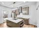 This kitchen features gray cabinets, stainless steel appliances, an island, and modern lighting fixtures at 8228 Moores Chapel Rd, Charlotte, NC 28214