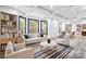 Bright living room featuring large windows, coffered ceiling, hardwood floors, and stylish modern decor at 8228 Moores Chapel Rd, Charlotte, NC 28214