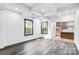 Well-lit living room showing hardwood floors, recessed lighting, and seamless access to the kitchen at 8228 Moores Chapel Rd, Charlotte, NC 28214