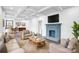 Bright living room featuring fireplace, hardwood floors, and view into the kitchen and dining area at 8228 Moores Chapel Rd, Charlotte, NC 28214