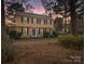 Evening view of a two-story house with a yellow exterior and blue door at 860 Nightingale Rd, Rock Hill, SC 29732