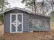 Gray storage shed with white double doors and lattice sides at 860 Nightingale Rd, Rock Hill, SC 29732