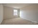 Well-lit bedroom with a window, neutral walls, and carpet flooring at 866 Two Brothers Ln, York, SC 29745