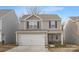 Two-story house with neutral siding, white garage door, and landscaping at 9025 Creedmore Hills Dr, Charlotte, NC 28214