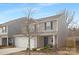 Two-story house with neutral siding, white garage door, and landscaping at 9025 Creedmore Hills Dr, Charlotte, NC 28214