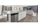 Kitchen island with granite countertop and stainless steel dishwasher at 9025 Creedmore Hills Dr, Charlotte, NC 28214