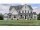 Two-story house with gray and white siding, stone accents, and a two-car garage at Lot 1 Mayes Meadow Dr # Devonshire, Cornelius, NC 28078