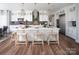 Bright kitchen with white cabinets, a white island, and light wood stools at Lot 1 Mayes Meadow Dr # Devonshire, Cornelius, NC 28078