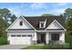 Bright home with white siding, a two-car garage, and stone accents creating curb appeal at Lot 109 Mayes Meadow Dr # Woodford, Cornelius, NC 28078