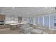 Open-concept living space with a modern kitchen, island seating, and sliding glass doors at Lot 109 Mayes Meadow Dr # Woodford, Cornelius, NC 28078