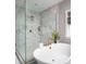 Bright bathroom featuring a glass shower, soaking tub, and tasteful marble tiling at Lot 11 Mayes Meadow Dr # Devonshire, Cornelius, NC 28078