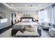 Inviting bedroom featuring a gray upholstered bed and a sitting area at Lot 11 Mayes Meadow Dr # Devonshire, Cornelius, NC 28078